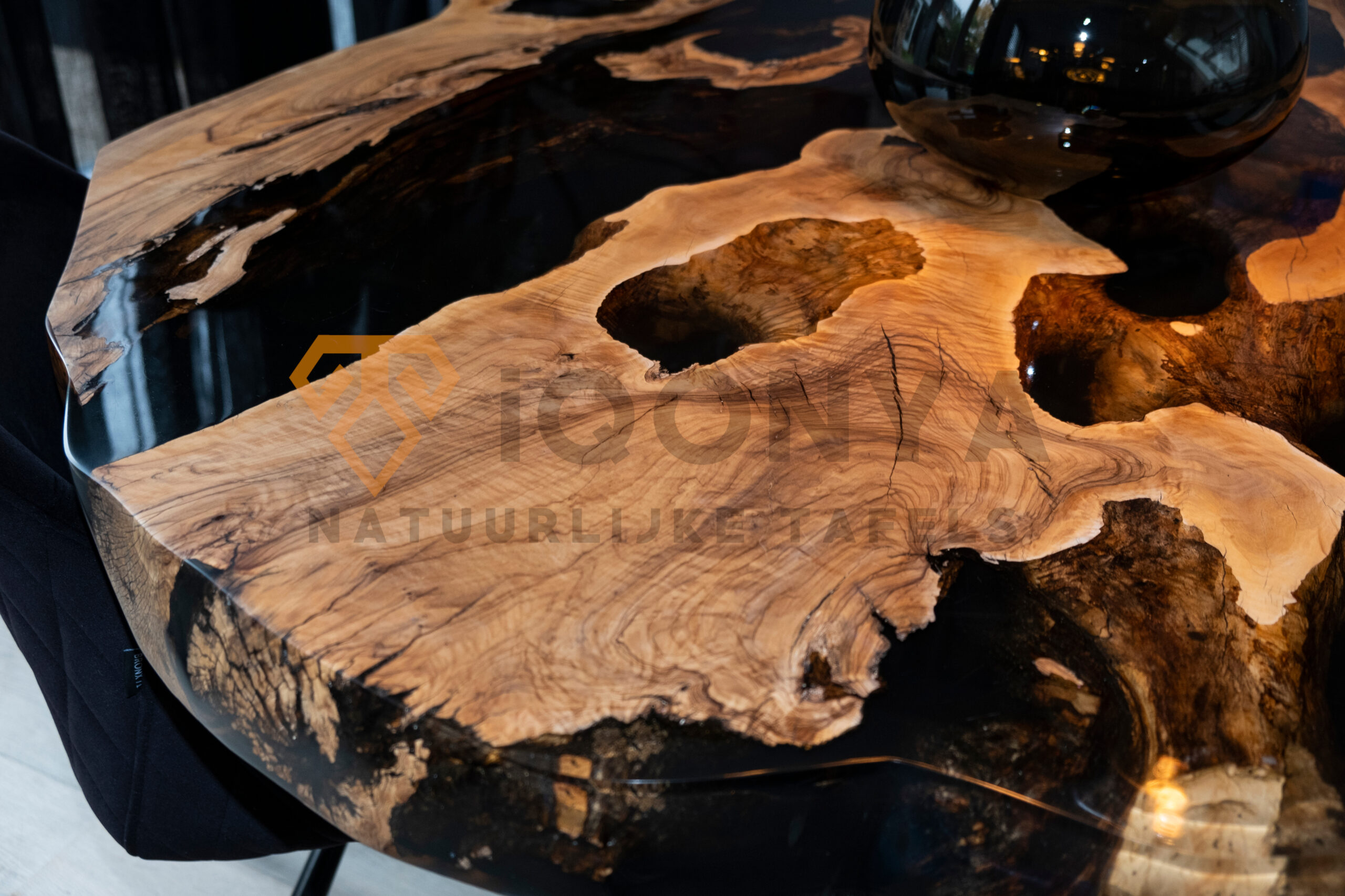 Table bord naturel ronde en résine époxy foncée et bois d'olivier, réalisée sur mesure